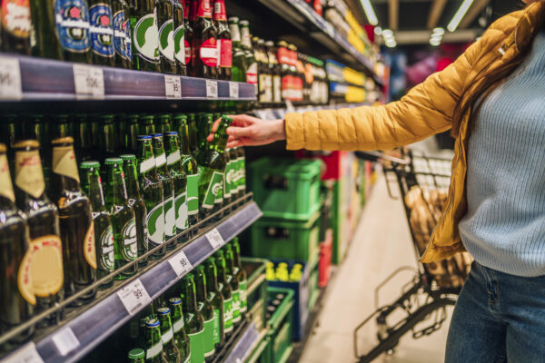 Customer buying beer in supermarket
