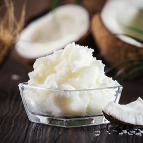 MCT Coconut butter or oil. Organic healthy food, beauty and SPA product. Wooden background. Copy space