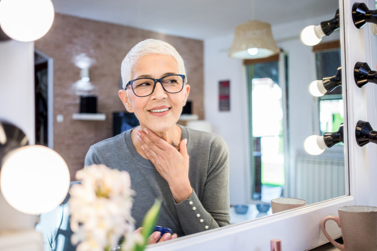 middle aged woman touching her face
